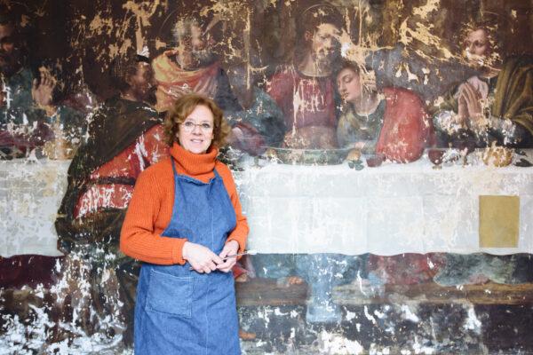 Conservator Rossella Lari with the painting “in progress.” (Camilla Cheade)