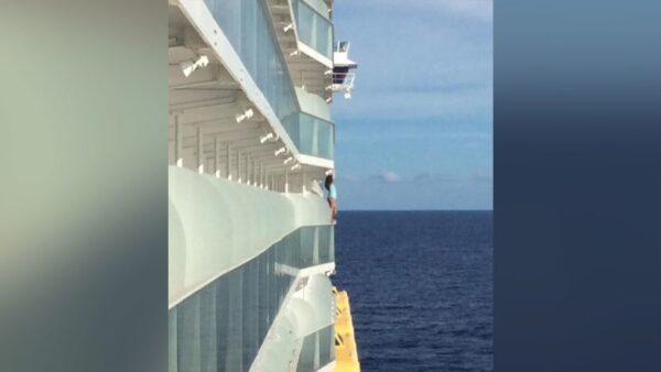 A woman was removed from a cruise ship and banned for life by the cruise company after she climbed onto her room's balcony railing to pose for a dangerous photo shoot over the ocean. (Courtesy Peter Blosic via CNN)