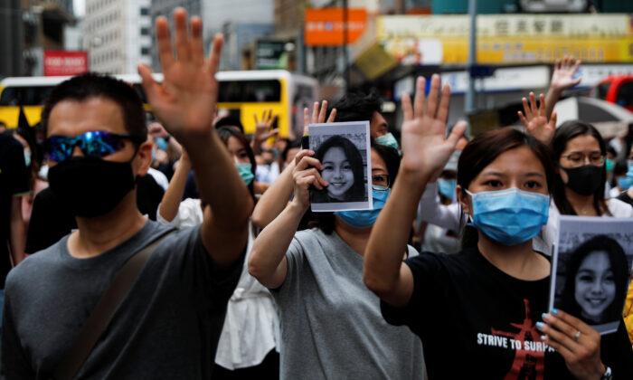 People march while holding up pictures of 15-year-old student Chan Yin-lam to protest against what they say is the abuse of pro-democracy protesters by Hong Kong police, in Central district, Hong Kong, China October 18, 2019. (Ammar Awad/Reuters)