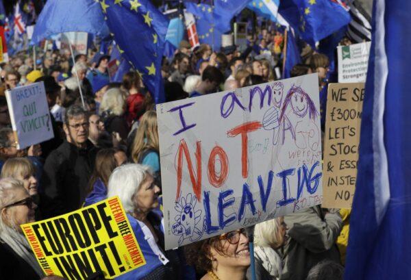 Anti-Brexit supporters carry signs and EU flags during a march in London on Oct. 19, 2019. (Kirsty Wigglesworth/AP)