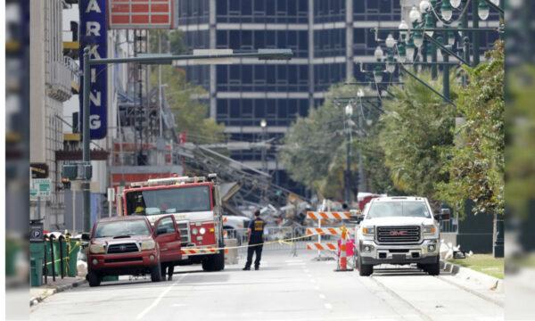 Fire department personnel stand by as workers prepare two unstable cranes for implosion at the collapse site of the Hard Rock Hotel in New Orleans, La., on Oct. 19, 2019. (Gerald Herbert/AP Photo)