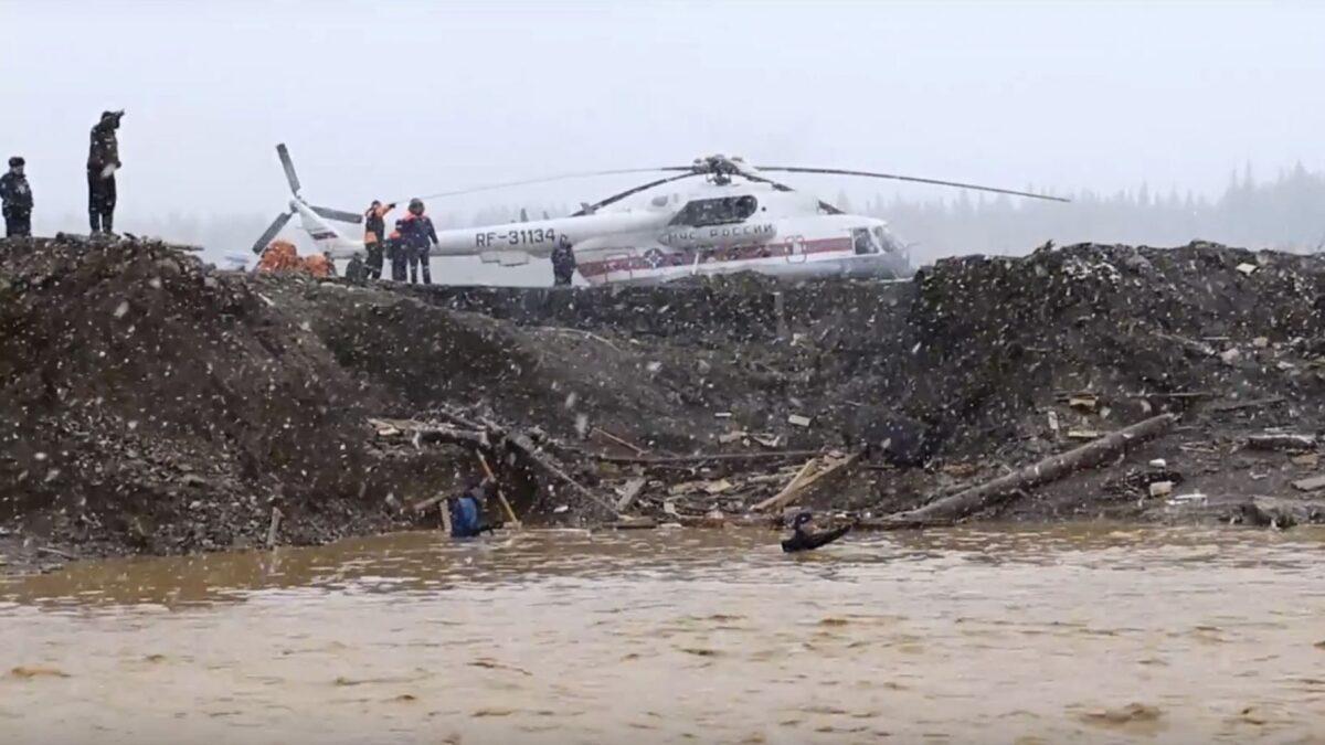 In this image made from video provided by Russian Emergency Situations Ministry press service, the view after a dam burst at a small gold mine in Siberia. (Russian Ministry of Emergency Situations press service via AP)