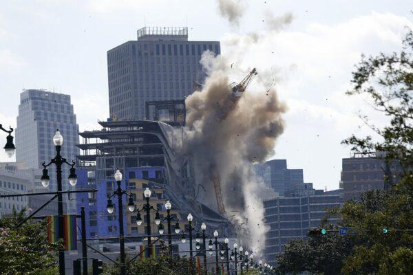 Two large cranes from the Hard Rock Hotel construction collapse come crashing down after being detonated for implosion in New Orleans, La., on Oct. 20, 2019. (Gerald Herbert/AP Photo)
