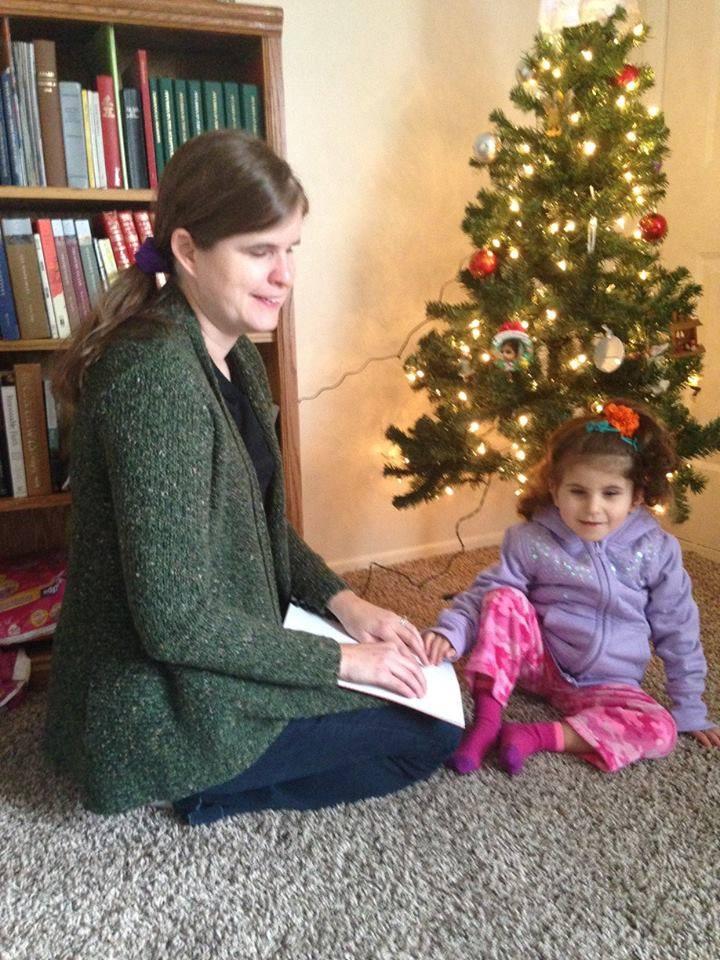 Ashley and Lexy reading braille. (Photo courtesy of <a href="https://www.facebook.com/ABlindView/">Ashley Wayne</a>)