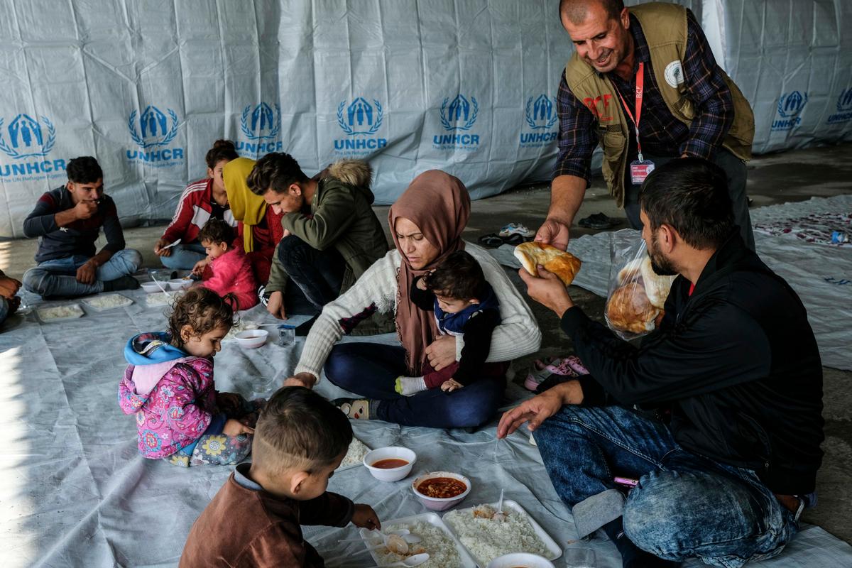 Syrian Kurdish refugees fleeing the Turkish incursion into Rojava rest and receive food at a Refugee Welcoming Committee base in Shaila, Iraq, on Oct. 20, 2019. (Photo by Byron Smith/Getty Images)