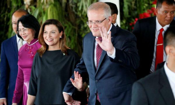Australian Prime Minister Scott Morrison and his wife Jennifer Morrison wave to journalists after attending the inauguration of Indonesia's President Joko Widodo for the second term, in Jakarta, Indonesia on Oct. 20, 2019. (Willy Kurniawan/Reuters)