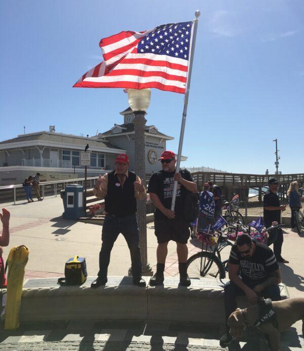 Two men hold an American flag in Newport Beach, Calif. on Oct. 19, 2019. (Ian Henderson/The Epoch Times)