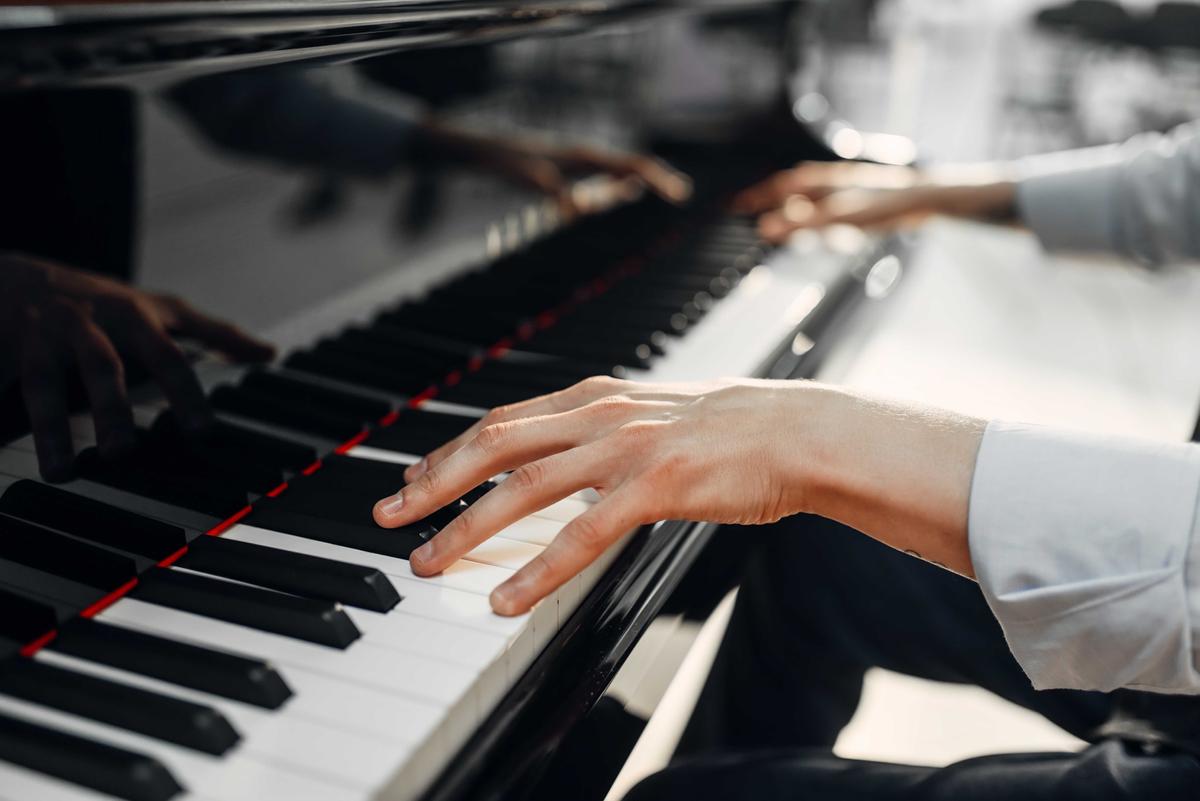 Illustration - Shutterstock | <a href="https://www.shutterstock.com/image-photo/male-pianist-hands-on-grand-piano-1140637370">Nomad_Soul</a>