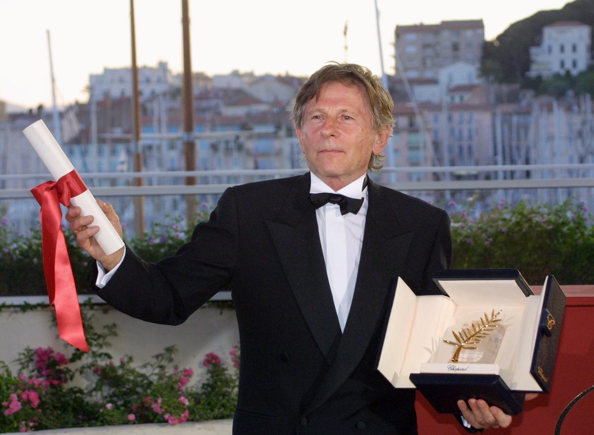 French-Polish-born director Roman Polanski poses for photographers after being awarded with the Golden Palm for his film "The Pianist" during the closing ceremony of the 55th Cannes film festival May 26, 2002. (Getty Images | <a href="https://www.gettyimages.com.au/detail/news-photo/french-polish-born-director-roman-polanski-poses-for-news-photo/518156116">ANNE-CHRISTINE POUJOULAT/AFP</a>)
