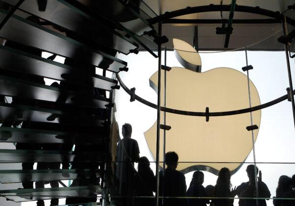 Apple employees line the stairs as they welcome customers during the opening of the first Apple retail store in Hong Kong on Sept. 24, 2011. (Dale de la Rey/AFP/Getty Images)