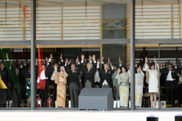Japanese dignitaries and government representatives raise their arms giving a banzai cheer during the enthronement ceremony of Japan's monarch Naruhito at the royal palace in Tokyo, Japan on Oct. 22, 2019. (Akio Kon/Pool via Reuters)