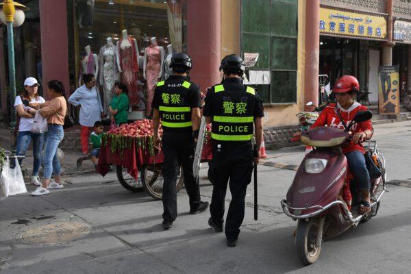 Police officers patrolling in Kashgar City, Xinjiang, China, on June 4, 2019. Authorities in the region have collected DNA samples from residents en masse. (Greg Baker/AFP/Getty Images)