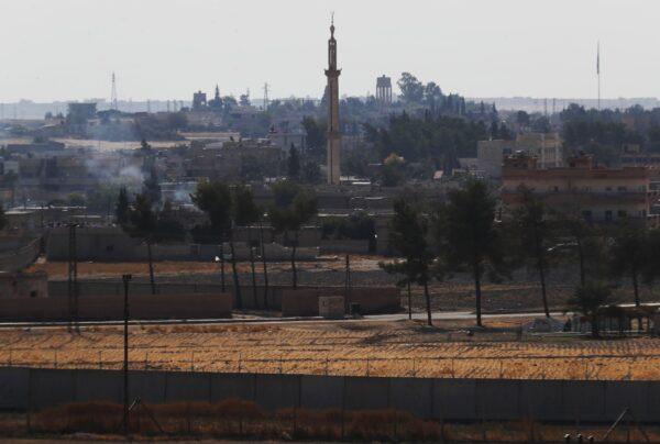 In this photo taken from the Turkish side of the border between Turkey and Syria, in Akcakale, Sanliurfa province, southeastern Turkey, a view of the town of Tal Abyad, Syria on Oct. 23, 2019. (Lefteris Pitarakis/AP Photo)