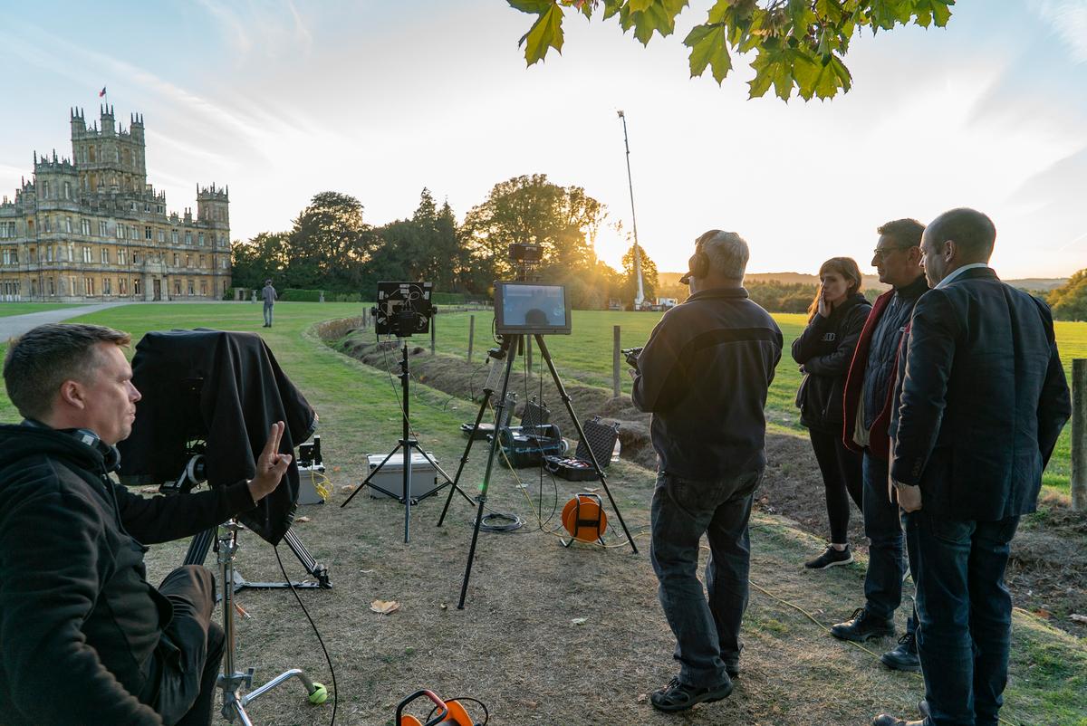 (L–R) Cinematographer Ben Smithard, director Michael Engler, and producer Gareth<br/>Neame watch the drone technician on the set of "Downton Abbey." (Liam Daniel/Copyright 2019 Focus Features, LLC)