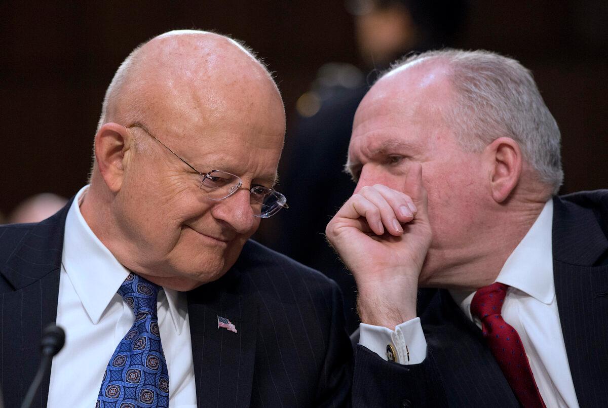 Director of National Intelligence James Clapper (L) and CIA Director John Brennan chat before testifying before the Senate Intelligence Committee on Feb. 9, 2016. (Molly Riley/AFP/Getty Images)