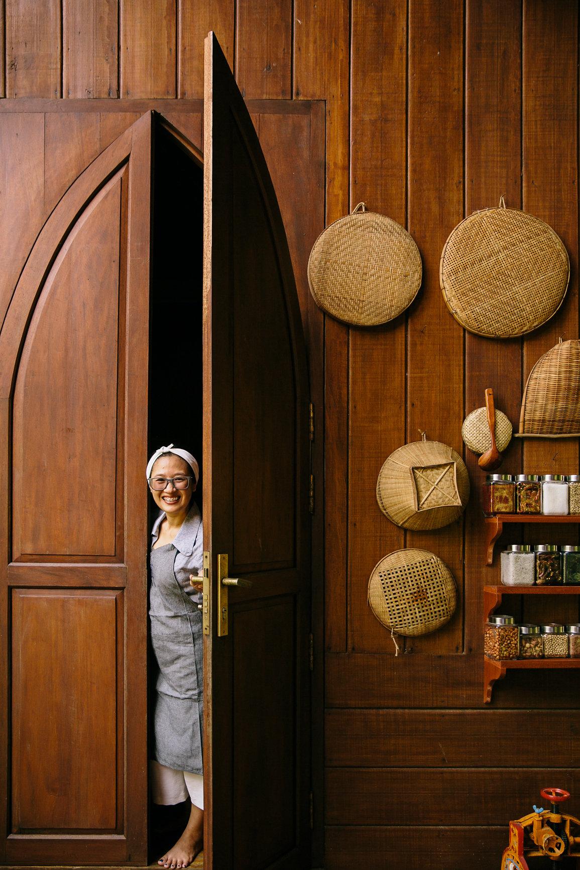 Rotanak Ros at the kitchen door of her wooden villa on the Mekong River, where she hosts private dinners and cooking classes on traditional Khmer cuisine. (Courtesy of Rosewood Phnom Penh)
