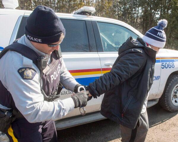 An asylum seeker from Colombia is arrested after crossing the border from New York into Hemmingford, Que., on Feb. 28, 2017.