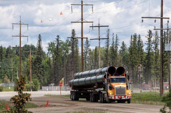 A truckload of pipes for the Trans Mountain pipeline in Edson, Alta., on June 18, 2019. (Jason Franson/The Canadian Press)