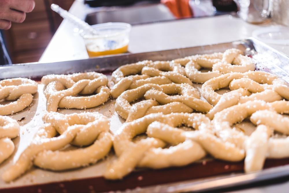 After a brush of egg wash and a generous pinch of salt, the pretzels are finished in the oven. (Shutterstock)