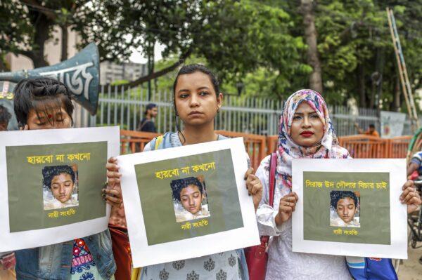 Bangladeshi women hold placards and photographs of schoolgirl Nusrat Jahan Rafi at a protest in Dhaka on April 12, 2019. (Sazzad Hossain/AFP/Getty Images)