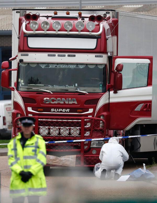 Police forensic officers attend the scene after a truck was found to contain a large number of dead bodies, in Thurrock, South England, Wednesday, Oct. 23, 2019. (Alastair Grant/AP)