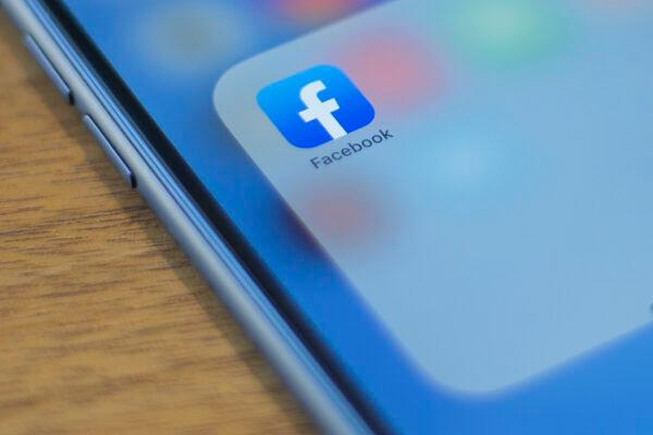 The Facebook logo is seen on a phone in this photo illustration in Washington on July 10, 2019. (Alastair Pike/AFP/Getty Images)
