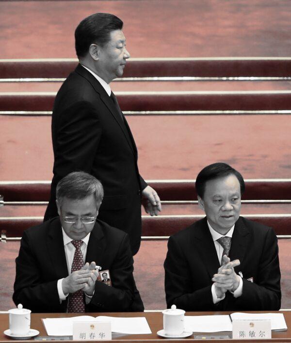 Chinese leader Xi Jinping Walks through Vice Premier Hu Chunhua and secretary of the Chongqing Municipal Party Committee Chen Min’er during the closing session of the National People's Congress (NPC) at the Great Hall of the People in Beijing, China on March 20, 2018. (Lintao Zhang/Getty Images)