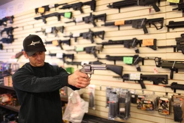 A salesman shows a customer a handgun in Delray Beach, Florida, on Jan. 5, 2016. (Joe Raedle/Getty Images)