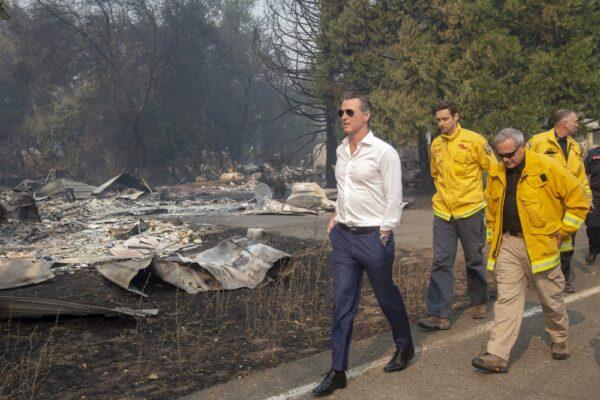 California Gov. Gavin Newsom (L), tours a home destroyed by the Kincade fire in Geyserville, Calif. on Oct. 25, 2019. (Karl Mondon/San Jose Mercury News via AP)
