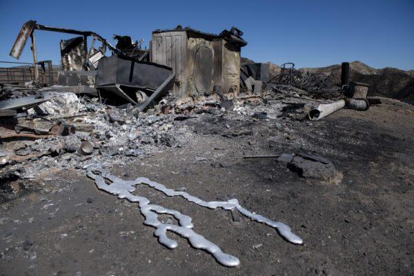 Debris from a hilltop home smolders after being burned by the Tick Fire on Oct. 25, 2019, in Santa Clarita, Calif. (Christian Monterrosa/AP Photo)