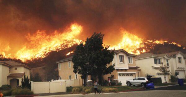 A wildfire approaches a residential subdivision on Oct. 24, 2019, in Santa Clarita, Calif. (Marcio Jose Sanchez/AP)