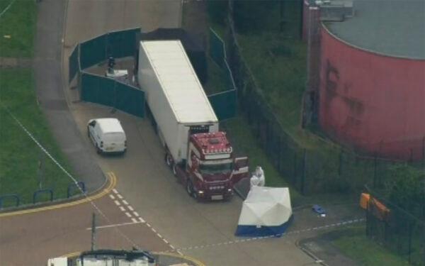 Police forensic officers attend the scene after a truck was found to contain a large number of dead bodies in Thurrock, South England on Oct. 23, 2019. (UK Pool via AP)