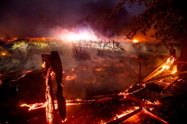 A fence burns in front of a vineyard as the Kincade Fire burns in Healdsburg, Calif., on Oct 27, 2019. (Noah Berger/AP Photo)