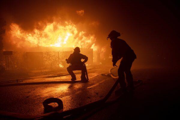 Firefighters try to save a home on Tigertail Road during the Getty fire in Los Angeles, Calif., on Oct. 28, 2019 (Christian Monterrosa/AP Photo)