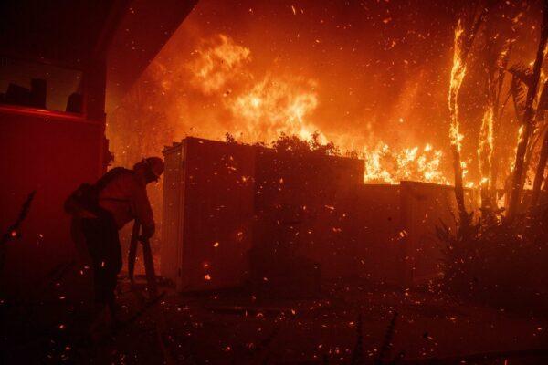 Firefighters try to save a home on Tigertail Road from the Getty fire in Los Angeles, Calif., on Oct. 28, 2019 (Christian Monterrosa/AP Photo)