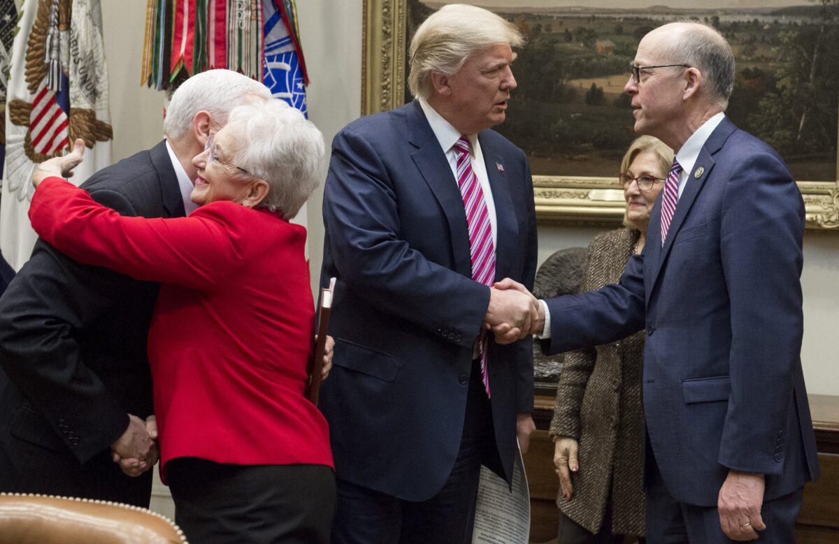 President Donald Trump shakes hands with Rep. Greg Walden (R-Ore.) as they meet with House committee chairman about healthcare reform in a 2017 file photograph. (Saul Loeb/AFP/Getty Images)