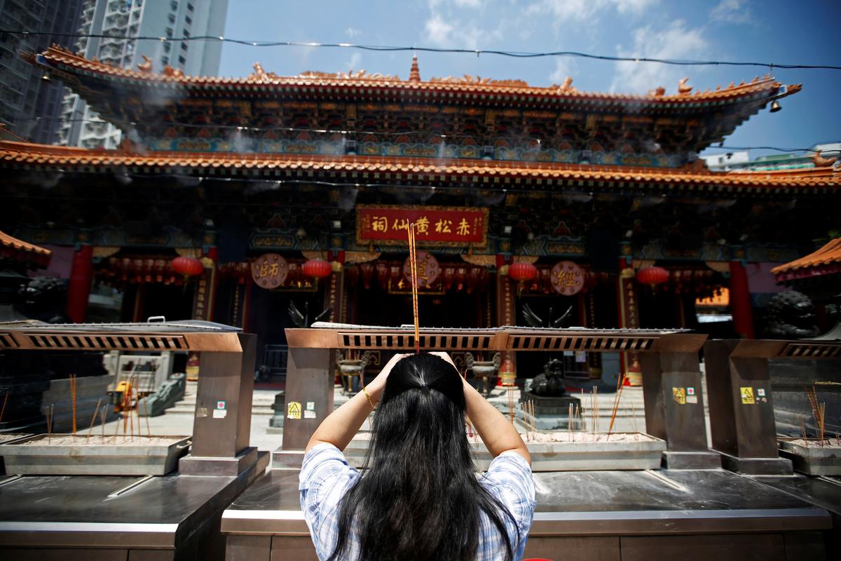 A devotee offers prayers at the Wong Tai Sin temple in Hong Kong on Oct. 2, 2019. (James Pomfret/Reuters)