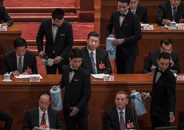 Chinese leader Xi Jinping (C) and other high-ranking members of the government are served tea during the third plenary session of the National People's Congress at the Great Hall of the People in Beijing on March 12, 2019. (Kevin Frayer/Getty Images)