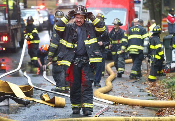 Woodbridge firefighters work the scene of fire after a plane crashed into a home located at 84 Berkeley Ave., in Woodbridge, N.J., on Oct. 29, 2019. (Noah K. Murray/AP Photo)