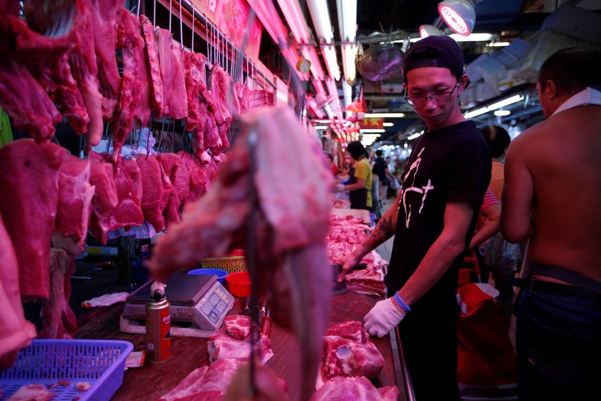 Chun Hui, a pork butcher in the Tai Shing market, stands in front of his stall in the Wong Tai Sin neighborhood of Hong Kong on Sept. 21, 2019. (James Pomfret/Reuters)