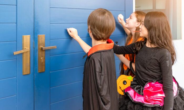 Boy Tired of the Traditional Trick-or-Treating Knocks on Doors With a Special Ad Sign