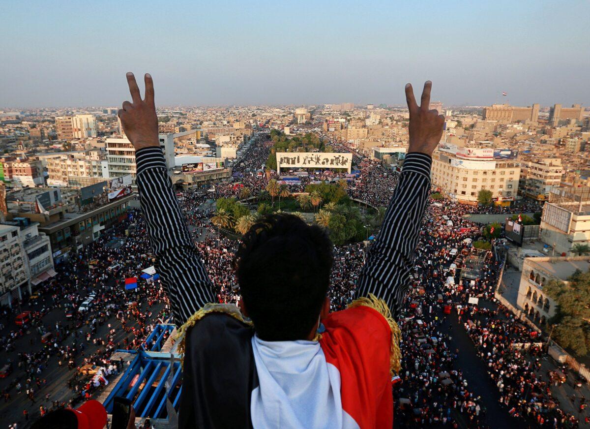 A protester gives the victory sign as thousands of anti-government protesters gather in Tahrir Square during ongoing demonstrations in Baghdad, Iraq, on Oct. 31, 2019. (Hadi Mizban/AP Photo)
