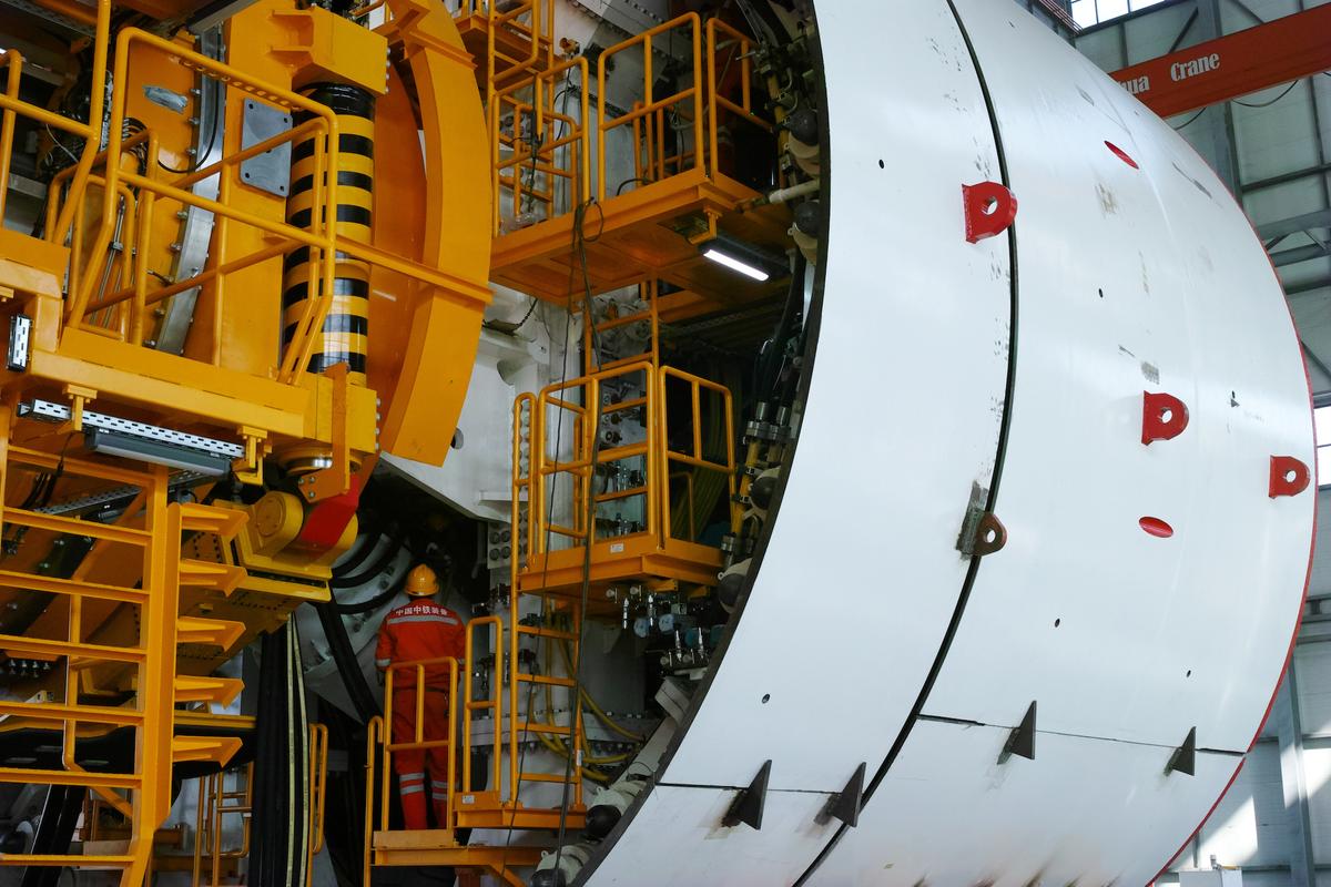 A worker inspects a tunnel boring machine (TBM) at a production facility of China Railway Engineering Equipment Group in Zhengzhou, Henan Province, China on Oct. 30, 2019. (Reuters)