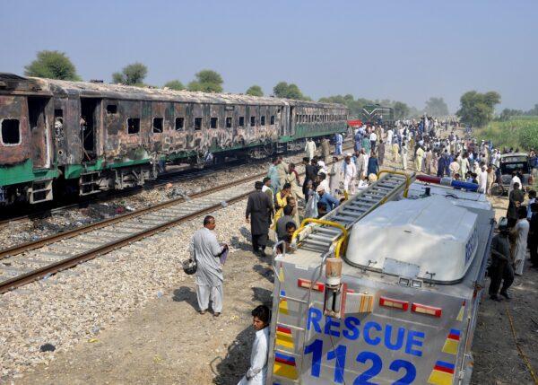 Pakistani soldiers and officials examine a train damaged by a fire in Liaquatpur, Pakistan on Oct. 31, 2019. (Siddique Baluch/AP Photo)