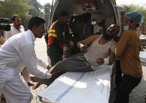 Hospital staff shift a man who was injured in a train fire, to a hospital in Multan, Pakistan on Oct. 31, 2019. (Asim Tanveer/AP Photo)