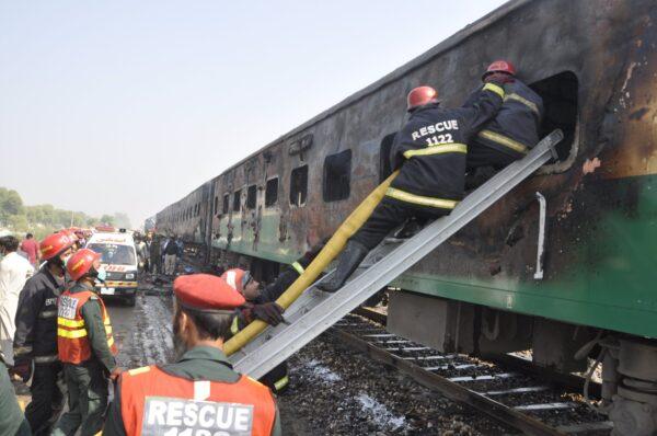 Rescue workers look for survivors following a train damaged by a fire in Liaquatpur, Pakistan on Oct. 31, 2019. (Siddique Baluch/AP Photo)