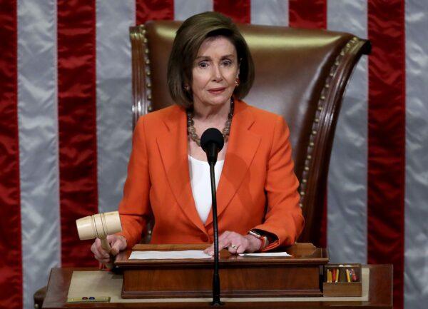 Speaker of the House Nancy Pelosi (D-CA) gavels the close of a vote by the U.S. House of Representatives on a resolution formalizing the impeachment inquiry centered on President Donald Trump in Washington, on Oct. 31, 2019. (Win McNamee/Getty Images)