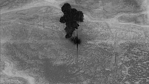 A smoke cloud rises moments after an air strike on the compound of ISIS leader Abu Bakr al-Baghdadi in the Idlib region of Syria from video taken Oct. 26, 2019. (U.S. Department of Defense/Reuters)