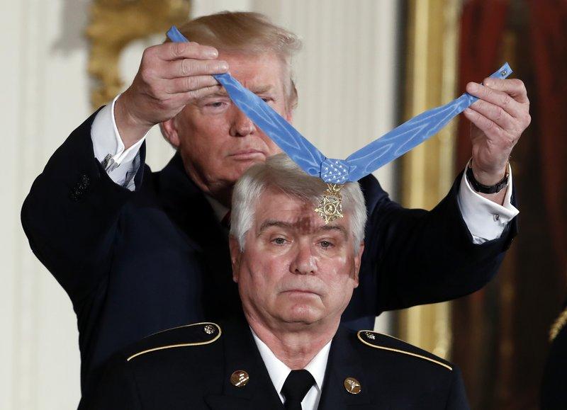 President Donald Trump bestows the nation's highest military honor, the Medal of Honor, to retired Army medic James McCloughan during a ceremony in the East Room of the White House in Washington on July 31, 2017. (Alex Brandon/AP Photo)