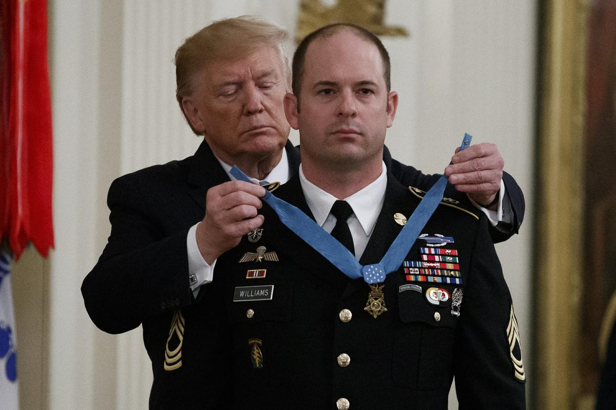 President Donald Trump places the Medal of Honor on Army Master Sgt. Matthew Williams, currently assigned to the 3rd Special Forces Group, during a Medal of Honor Ceremony in the East Room of the White House on Oct. 30, 2019, in Washington. (Alex Brandon/AP Photo)